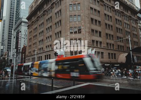 A light rail car crosses the intersection of Market St and George street on a rainy day in the CBD. Stock Photo