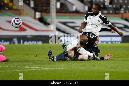 London, UK. 13th Mar, 2021. Fulham's Josh Onomah (top) shoots during the English Premier League match between Fulham and Manchester City at Craven Cottage in London, Britain on March 13, 2021. Credit: Han Yan/Xinhua/Alamy Live News