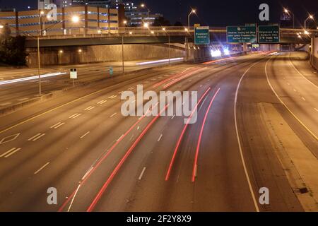 Atlanta, Ga USA - 06 14 20: Red Light trails and police lights on the interstate at night downtown Atlanta Stock Photo