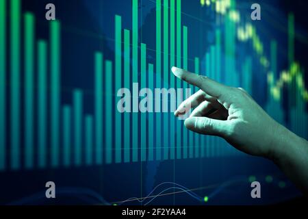 Businessman touching forex charts and diagrams stock market display on board. Stock Photo