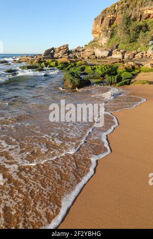 Wave rolls up the sand at Killcare Putty Beach - NSW Australia. Stock Photo