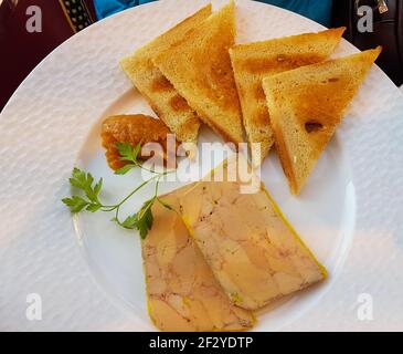 A cut in half sandwich sitting on top of a paper plate Stock Photo