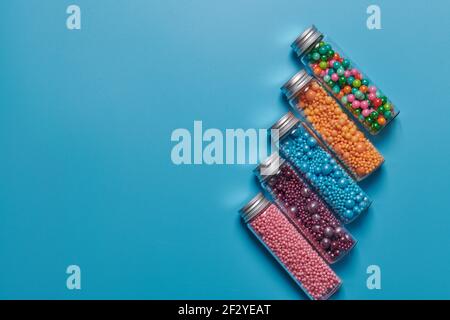 candy in jars on a blue background Stock Photo