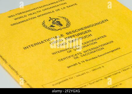 International vaccination card from the World Health Organization. Yellow vaccination certificate with proof of vaccinations. Travel document Stock Photo