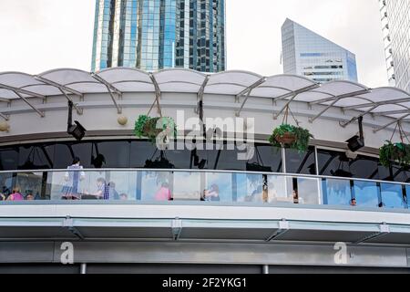 Brisbane, Queensland, Australia - March 2021: People dining at a city restaurant with high rises in the background Stock Photo