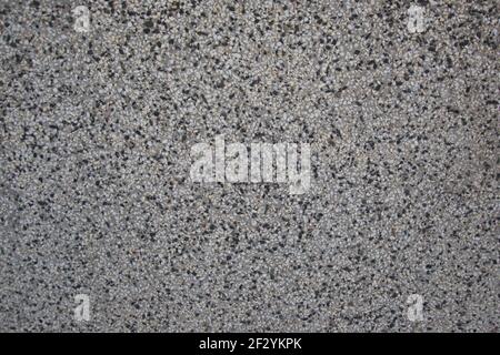 Rough textured wall made from black and white pebbles, abstract background, wall pattern, grunge rock backdrop Stock Photo