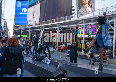 New York, United States. 13th Mar, 2021. A model poses for a photo during a fashion shoot in Manhattan's Times Square in New York City. Credit: SOPA Images Limited/Alamy Live News Stock Photo