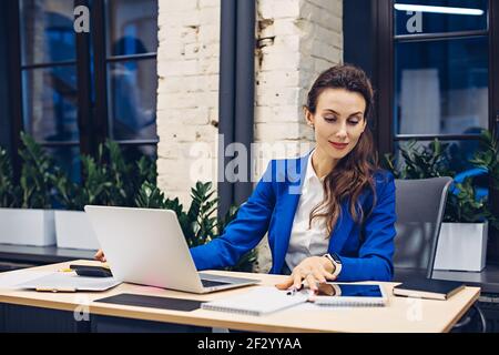 Businessman working on laptop and using tablet Stock Photo