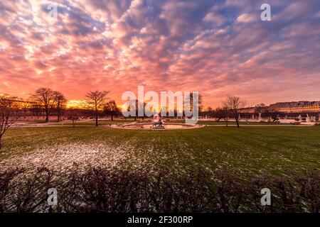 Paris, France - February 12, 2021: Tuileries Garden in Paris covered with snow at beautiful sunset Stock Photo