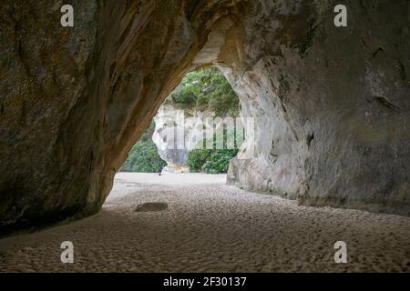 Coastal area named Cathedral Cove seen through a rock arch in the southern part of Mercury Bay on the Coromandel Peninsula at the North Island of New Stock Photo