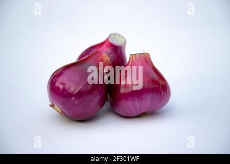 Red onion isolated on white background. close-up photoshoot	 Red onion isolated on white background. close-up photoshoot Stock Photo
