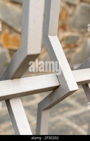 Minimalist geometry in the contrast of twisted white iron, details of the urban landscape that surround us anonymously. Stock Photo