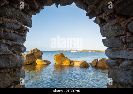Stone window of Venetian castle overlooking sea. Naoussa, Paros island, Greece. Stock Photo