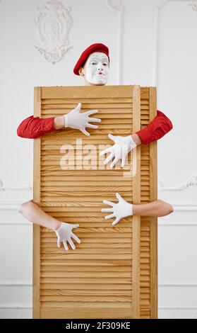 Two mime artists, scene with wooden partition Stock Photo
