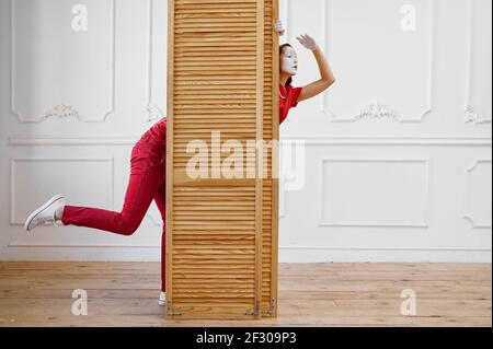 Two mime artists, scene with wooden partition Stock Photo