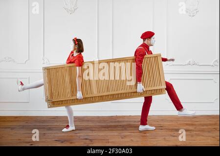Two mime artists, clowns with wooden partition Stock Photo