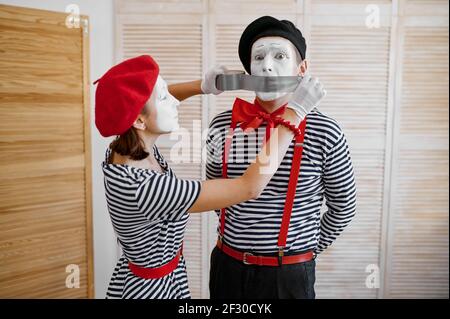 Two mime artists with duct tape, parody comedy Stock Photo