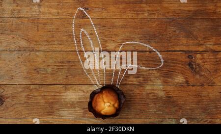 Tasty Easter cupcakes with ears on a wooden background Stock Photo