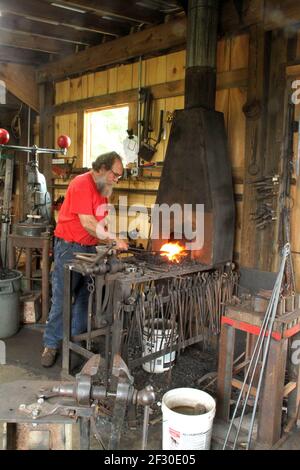 Blacksmith working in his workshop Stock Photo
