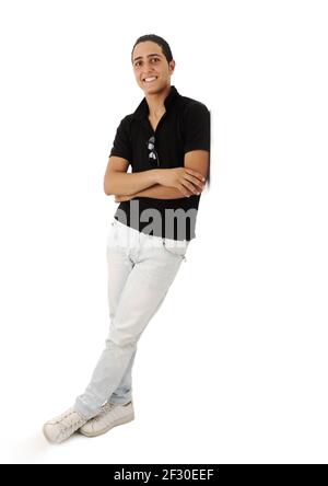 Arabic guy standing against the wall smiling, isolated Stock Photo