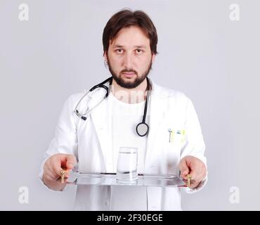 Young male doctor in white standing Stock Photo
