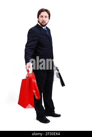 Young attractive man wearing suit and holding shopping bags Stock Photo