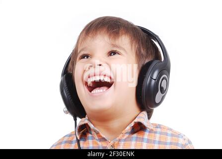 Little nice boy listening to music with peaceful expression on face Stock Photo