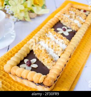 Chocolate-butterscotch mazurek with nuts in honey. Traditional Polish cake with a crispy base, baked on the occasion of Easter. Stock Photo