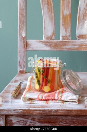 Pickled colorful carrots with thyme and ginger Stock Photo