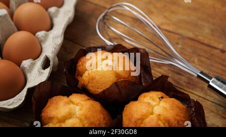 Baked cupcakes and muffins on a rustic wooden background Stock Photo
