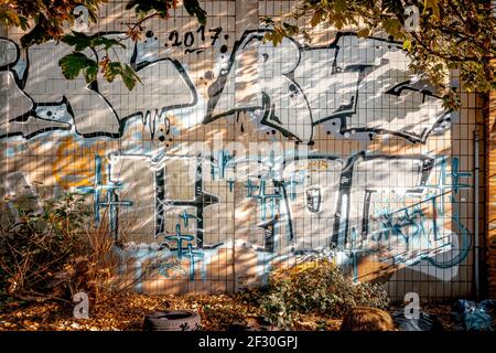 Graffiti work in an industrial teal & orange atmosphere Stock Photo