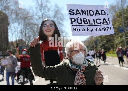 Madrid, Spain. 14th March, 2021. An elderly demonstrator from the social movement ‘marea blanca’, or white tide, takes part in a protest against the privatisation of the public health and the management of the covid-19 crisis by government in Madrid, Spain, on Sunday March 14th, 2021. Credit: Isabel Infantes/Alamy Live News Stock Photo