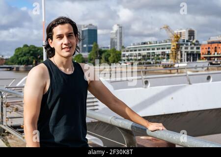 PORTRAIT of a Young Latino in the docks of the port. Concept modeling Stock Photo
