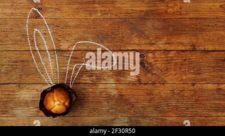 Tasty Easter cupcakes with ears on a wooden background Stock Photo