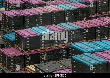 Marbach, Germany-March 12.2021:car parts lie in transport boxes that are stacked on top of each other on euro pallets Stock Photo
