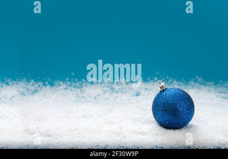Blue Christmas ball isolated on blue background. Stock Photo