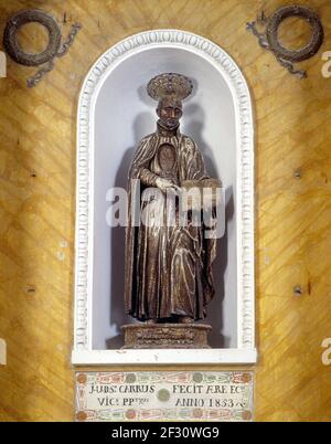 Itsly Sardinia Province of Nuoro - Oliena Saint  Ignazio di Loyola - polychrome wooden statue of Saint Ignatius of Loyola showing the book of the 'Constituciones de la Compania de Jesus' - 18th century Stock Photo