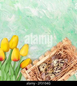 Yellow tulips bouquet and nest with quail eggs on green mint background. Postcard for Easter or spring postcard. Copy space Stock Photo