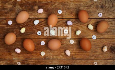 Eggs on a wooden rustic background. Fresh chicken eggs and decorative eggs Stock Photo