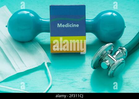 Medicine box, stethoscope and weight for physical exercise symbolizing mental balance at pandemic time Stock Photo