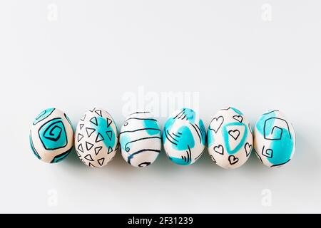 Creative trendy painted easter eggs on white background. Easter ideas. Stock Photo