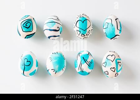 Creative trendy painted easter eggs on white background. Easter ideas. Stock Photo