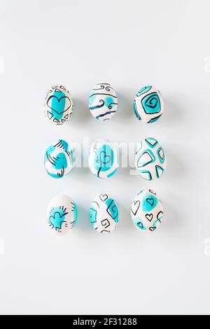 Creative trendy painted easter eggs on white background. Easter ideas. Stock Photo