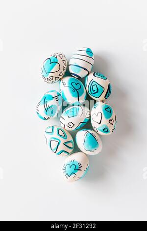 Creative trendy painted easter eggs on white background. Easter ideas. Stock Photo