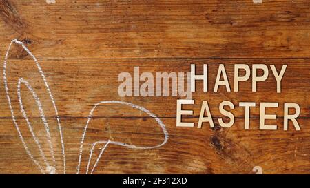 Chalk-drawn ears. Rabbit ears on a wooden background. Happy easter Stock Photo