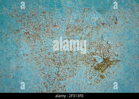Brown, gray and orange rust on turquoise painted metal surface. Corroded metal background. Oxidized metal texture with brass and aqua patina, rusty me Stock Photo