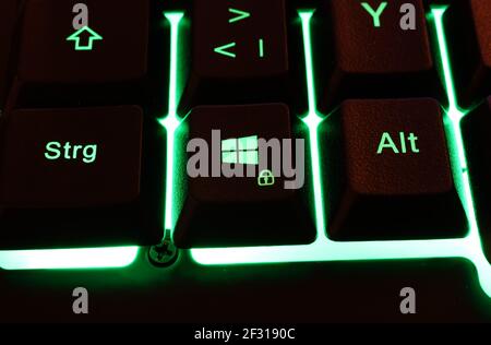 Computer keyboard green illuminated with euro symbol. News Photo - Getty  Images