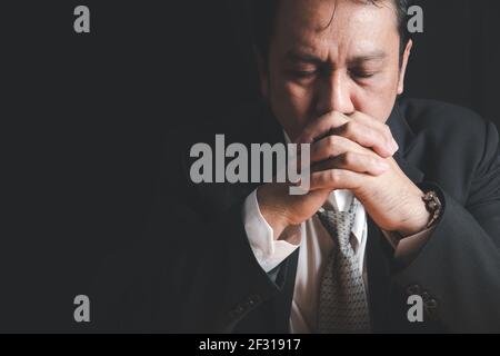 Stressed businessmen put their hands together while reviewing stories about business performance,Work stress problems concept. Stock Photo