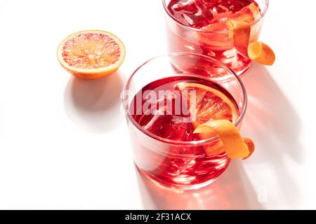 Negroni cocktails with blood oranges and ice on a white background Stock Photo