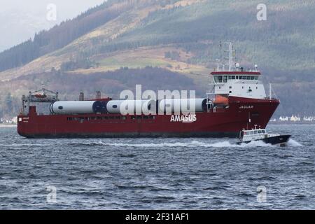 Jaguar, a general cargo vessel operated by Amasus Shipping, with the Clydeport pilot boat Mount Stuart, passing Gourock on the Firth of Clyde. Stock Photo